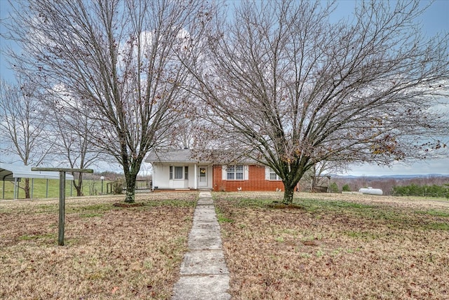 view of front of house with a front lawn and brick siding