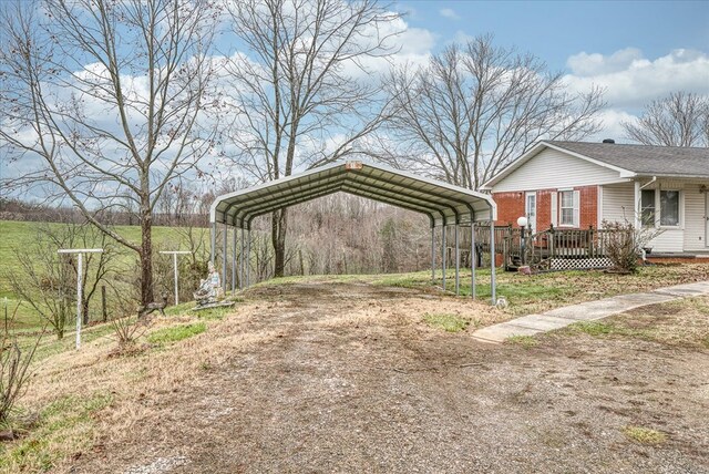 view of yard with a detached carport and driveway