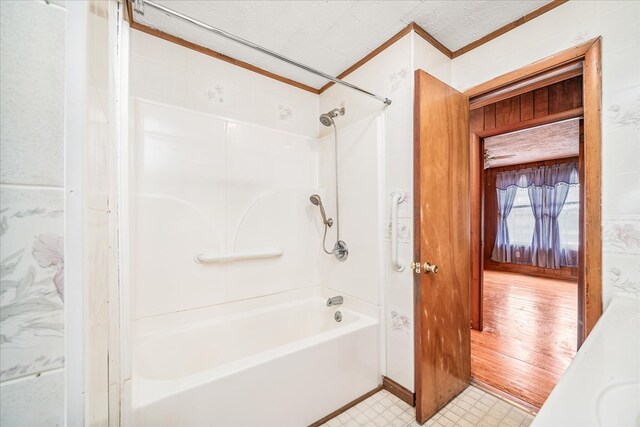 full bath with a textured ceiling,  shower combination, and tile patterned floors