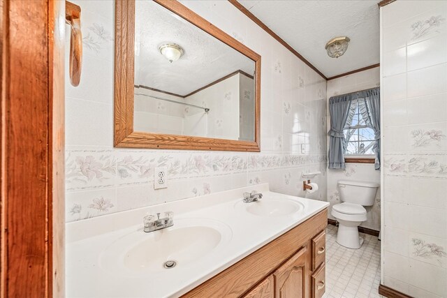 bathroom with a sink, toilet, and a textured ceiling