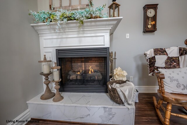 interior details with a warm lit fireplace and baseboards