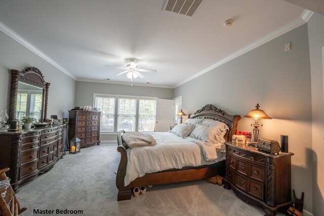 bedroom featuring crown molding, visible vents, and light colored carpet