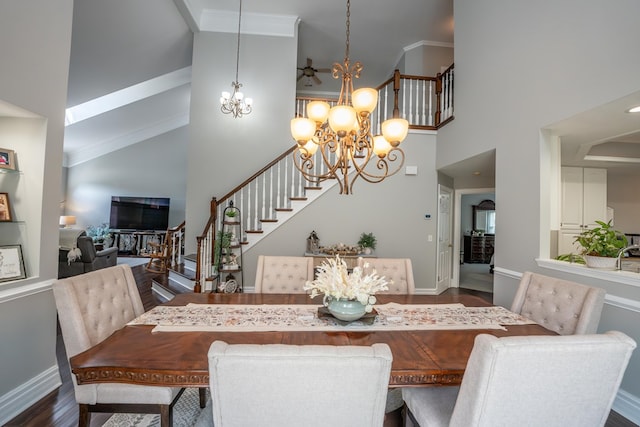 dining area featuring crown molding, dark wood-style flooring, a notable chandelier, and stairs