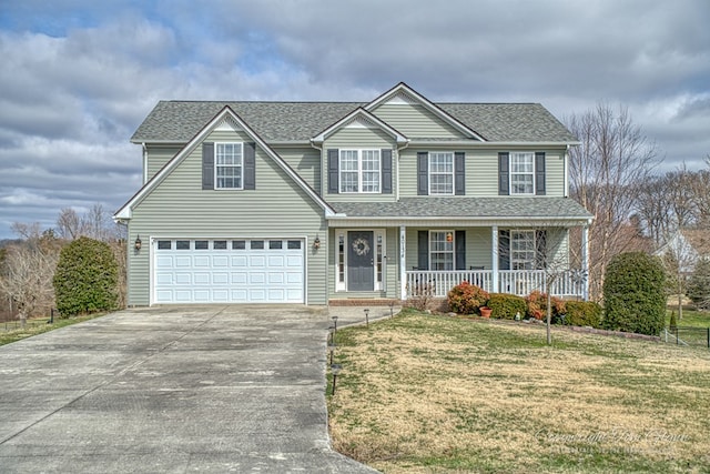 traditional home featuring a shingled roof, covered porch, an attached garage, a front yard, and driveway