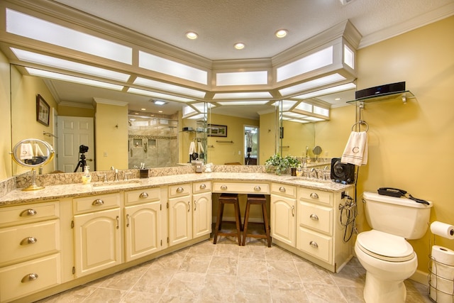 bathroom featuring ornamental molding, a sink, a shower stall, and double vanity