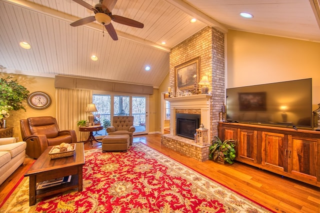 living area featuring wooden ceiling, recessed lighting, wood finished floors, a brick fireplace, and beam ceiling