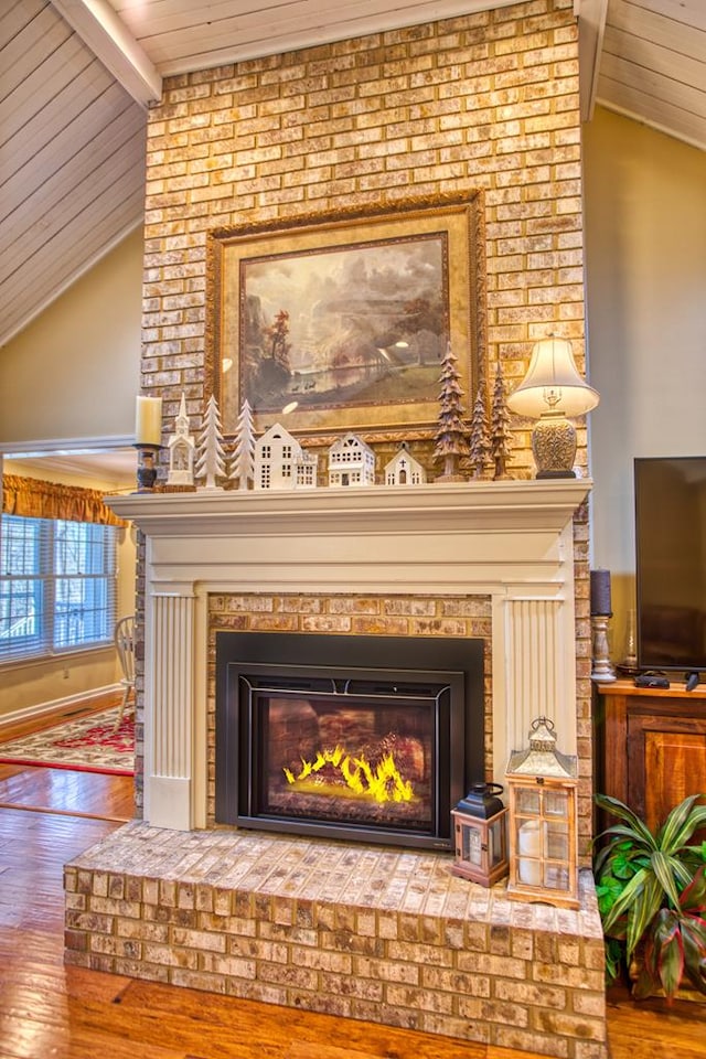 interior details with wood ceiling, a fireplace, wood finished floors, and beamed ceiling