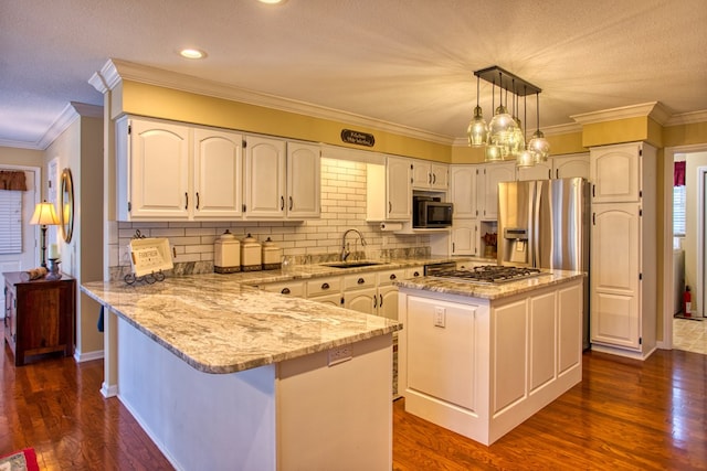 kitchen featuring a peninsula, dark wood-style flooring, a sink, appliances with stainless steel finishes, and light stone countertops