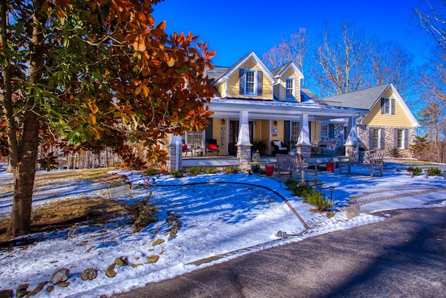 view of front of property featuring stone siding and covered porch