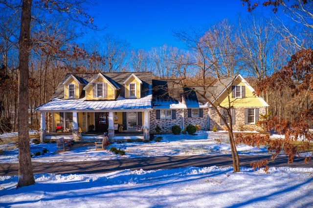 view of front of home with a porch and stone siding