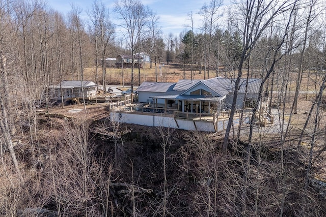 back of house with metal roof