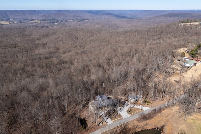 drone / aerial view featuring a wooded view