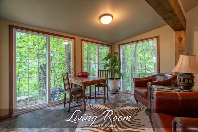 dining space with lofted ceiling and stone finish flooring