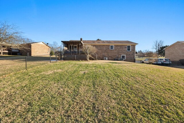 view of front facade featuring a deck, a front lawn, fence, and stairs