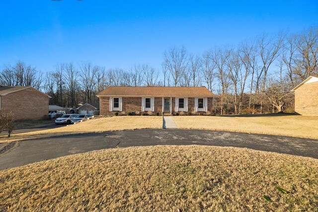 ranch-style home with a front lawn and brick siding