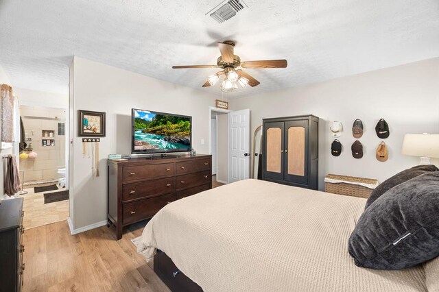 bedroom with visible vents, light wood-style flooring, a ceiling fan, a textured ceiling, and baseboards