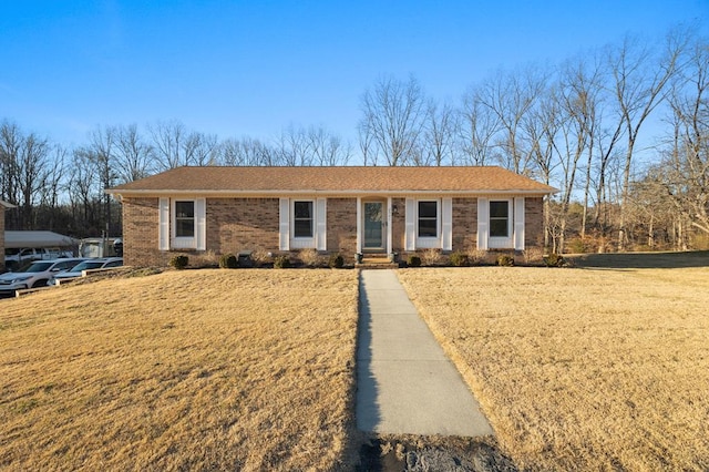 ranch-style house featuring brick siding and a front yard