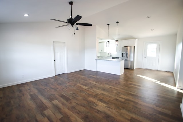 unfurnished living room featuring baseboards, dark wood finished floors, ceiling fan, high vaulted ceiling, and recessed lighting