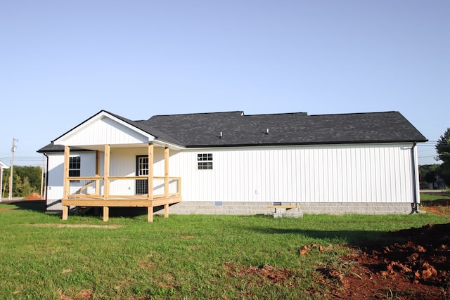 rear view of house with crawl space, a yard, and a deck