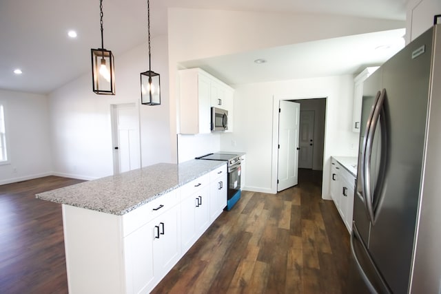 kitchen featuring light stone counters, decorative light fixtures, appliances with stainless steel finishes, white cabinets, and vaulted ceiling