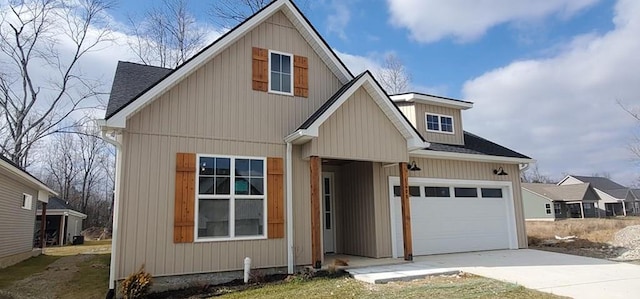 view of front facade with driveway, a shingled roof, and a garage