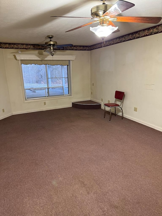 unfurnished room with carpet, baseboards, and ceiling fan