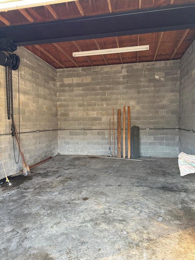 garage with concrete block wall