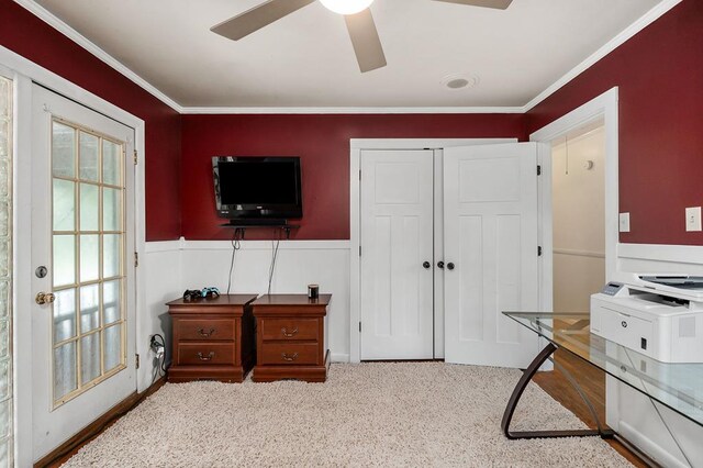 office with ornamental molding, wainscoting, and ceiling fan