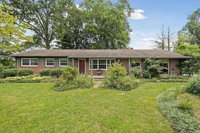 single story home with a front lawn and brick siding