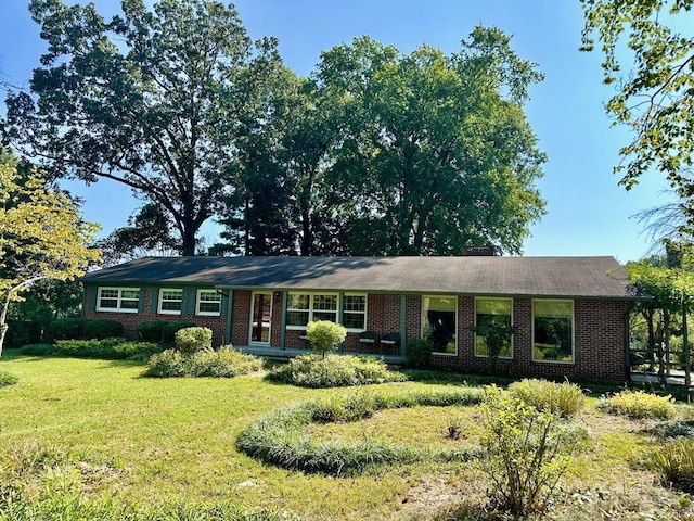 ranch-style house with brick siding and a front lawn