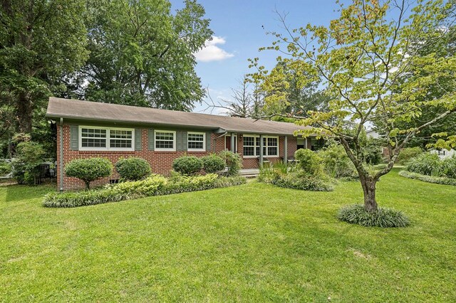 single story home with a front yard and brick siding