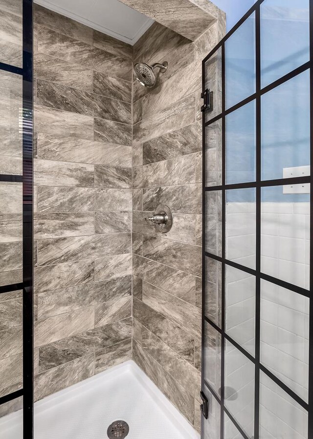 full bath with a tile shower