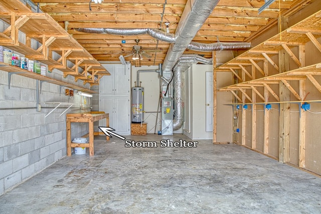 basement with water heater and concrete block wall