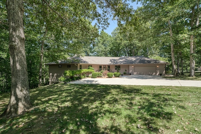 single story home featuring an attached garage, concrete driveway, and a front yard