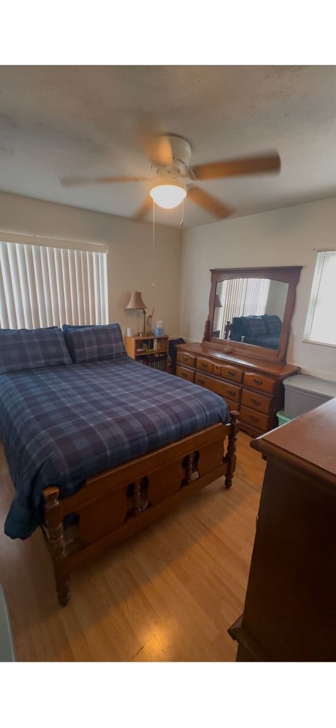 bedroom with ceiling fan and wood finished floors