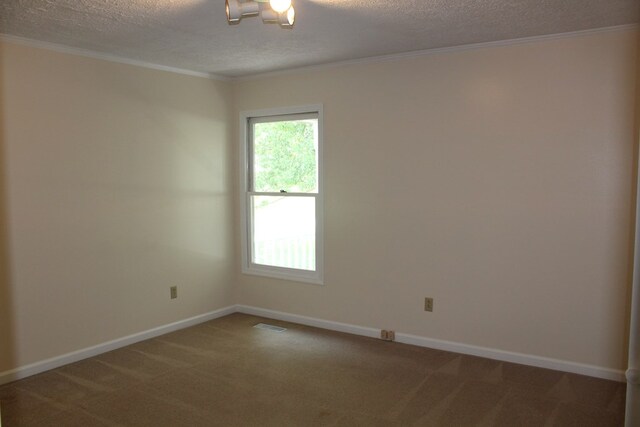 carpeted spare room featuring a textured ceiling, baseboards, and crown molding