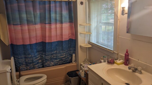 bathroom with vanity, toilet, and shower / bath combo with shower curtain