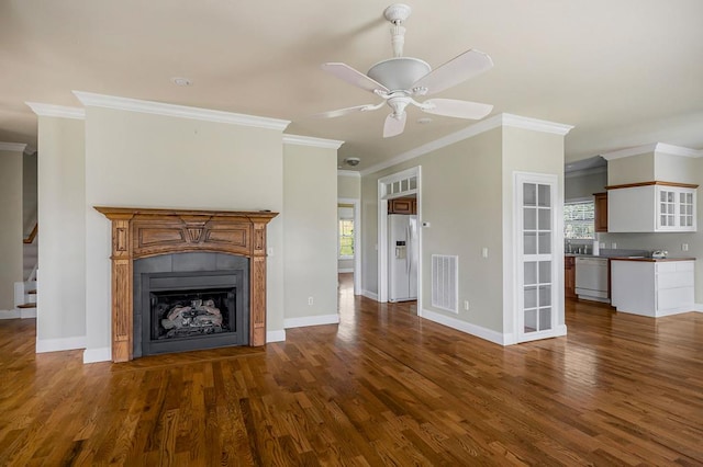 unfurnished living room with baseboards, a fireplace with flush hearth, ceiling fan, dark wood-type flooring, and stairs