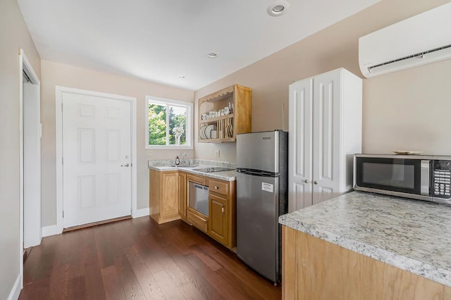 kitchen with a wall unit AC, dark wood finished floors, light countertops, appliances with stainless steel finishes, and a sink