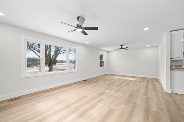 unfurnished living room featuring a ceiling fan, light wood-style flooring, recessed lighting, and baseboards