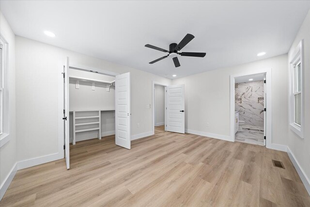 unfurnished bedroom featuring recessed lighting, baseboards, light wood-type flooring, and a closet