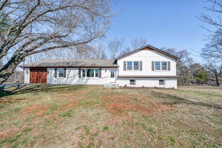 tri-level home with a front lawn