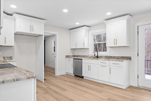 kitchen featuring recessed lighting, light wood-type flooring, stainless steel dishwasher, and white cabinetry