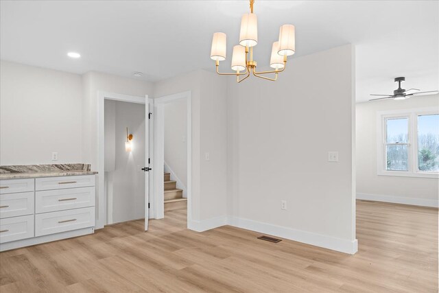 unfurnished dining area featuring visible vents, recessed lighting, light wood finished floors, baseboards, and a chandelier