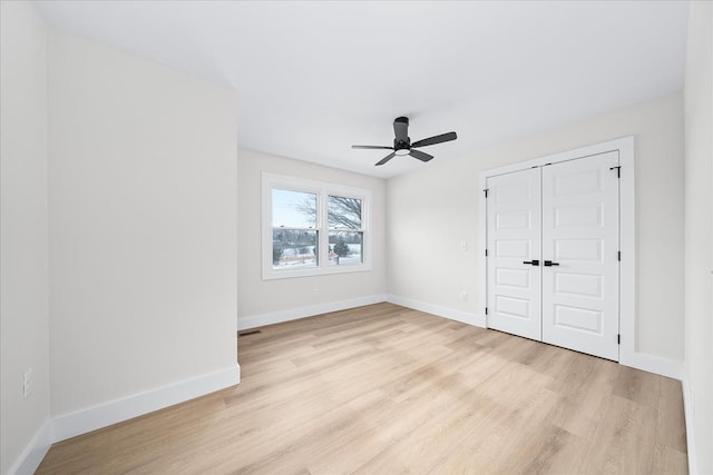 unfurnished bedroom with visible vents, ceiling fan, baseboards, light wood-type flooring, and a closet