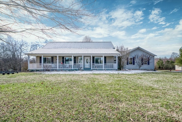 farmhouse with metal roof, a front lawn, and a porch