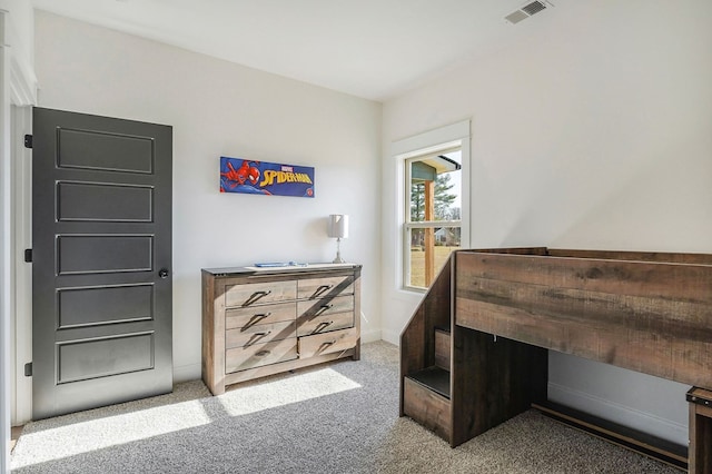 carpeted bedroom featuring baseboards and visible vents