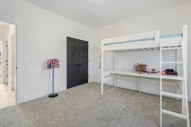 bedroom featuring carpet floors, a closet, and baseboards