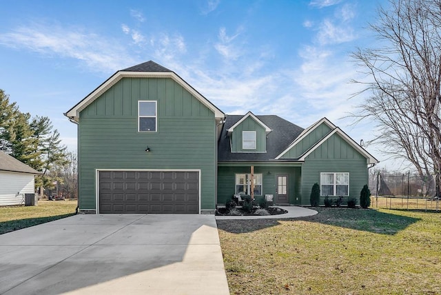 view of front of property featuring driveway, a front lawn, and board and batten siding