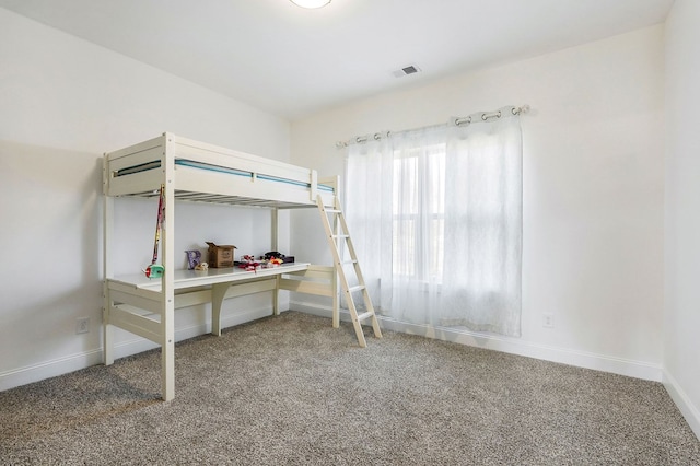 bedroom with carpet, visible vents, and baseboards